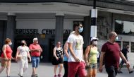  People wearing masks walk at a street as the novel coronavirus (COVID-19) cases have reached to 73,401 on August 09, 2020, in Brussels, Belgium.  Dursun Aydemir - Anadolu