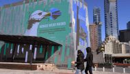 A sign in Federation Square urges people to wear a mask in the central business district in Melbourne on August 6, 2020./ AFP / William WEST