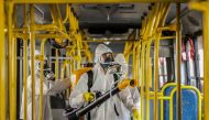 Military personnel from the Brazilian Armed Forces sanitize a bus at the Santa Candida bus terminal to combat the spread of the the novel coronavirus, COVID-19, in Curitiba, Parana State, Brazil, on August 10, 2020. / AFP / Daniel CASTELLANO