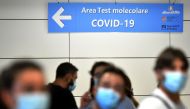 Passengers queue to be screened for Covid-19 at a testing station set up at Fiumicino airport, near Rome, on August 16, 2020. Italy has introduced mandatory Covid-19 (novel coronavirus) testing for anyone arriving from Croatia, Greece, Spain and Malta and