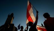 People holding Belarussian flags take part in a demostration in support of protests against the results of the Belarusian presidential election, on August 16, 2020 in Prague, Czech Republic. / AFP / Michal Cizek