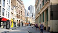 Pedestrians, some wearing a face mask or covering due to the COVID-19 pandemic, walk along a quite shopping street in London on August 12, 2020. AFP / Tolga Akmen