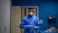 A healthcare worker holds a sample at a temporary testing centre for the novel coronavirus in Madrid on August 17, 2020.  / AFP / OSCAR DEL POZO