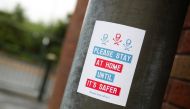 A view shows a sign advising people to stay home, amid the outbreak of the coronavirus disease (COVID-19), in Oldham, Britain, August 19, 2020. REUTERS/Molly Darlington
