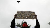 A protester holds a placard during a demonstration against suspected corruption in the response of the Kenyan government to the coronavirus disease (COVID-19) outbreak, in Nairobi, Kenya, August 21, 2020. REUTERS/Baz Ratner