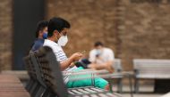 Students at New York University (NYU) wait outside of a Covid-19 test tent outside of its business school on August 25, 2020 in New York City. Spencer Platt/AFP  
