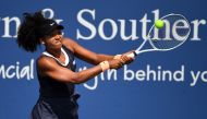 Aug 28, 2020; Flushing Meadows, New York, USA; Naomi Osaka (JPN) returns the ball against Elise Mertens (BEL) during the Western & Southern Open at the USTA Billie Jean King National Tennis Center. Mandatory Credit: Robert Deutsch-USA TODAY Sports