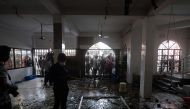 Shattered glasses are seen inside a mosque following a fire in the central district of Narayanganj, on September 5, 2020.   AFP / Munir UZ ZAMAN