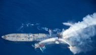 This handout photograph taken on September 6, 2020, and released by Sri Lanka's Air Force shows fireboats battling to extinguish a fire on the Panamanian-registered crude oil tanker New Diamond, some 60 kms off Sri Lanka's eastern coast where a fire was r