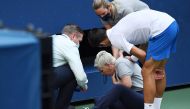 Sep 6, 2020; Flushing Meadows, New York, USA; Novak Djokovic of Serbia and a tournament official tend to a linesperson who was struck with a ball by Djokovic against Pablo Carreno Busta of Spain (not pictured) on day seven of the 2020 U.S. Open tennis tou