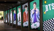 A man walks past commercial posters showing K-pop group BTS members outside a duty free shop in Seoul on September 1, 2020. AFP / Jung Yeon-je
 