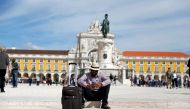 FILE PHOTO: A tourist rests at Comercio square in downtown Lisbon, Portugal April 11, 2019. Picture taken April 11, 2019. REUTERS/Rafael Marchante/File Photo
