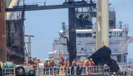 This handout picture taken on September 10, 2020, and released on September 11, 2020 by Sri Lanka Navy shows international salvage experts boarding the fire-stricken tanker, New Diamond, in the Indian Ocean off Sri Lanka's eastern coast. AFP PHOTO / Sri L