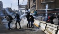 Security forces try to disperse protesters with tear gas during a demonstration called by the 