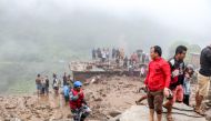 Rescue workers and residents gather for search at the scene of a landslide following heavy rains in Bahrabise municipality of Sindhupalchok district, some 90 kms northeast of Kathmandu on September 13, 2020. / AFP / NIROJ CHAOULAGAIN