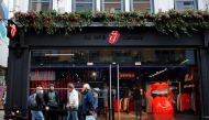 People queue to enter The Rolling Stones new flagship store in London on September 9, 2020, ahead of it's first day of opening.  / AFP / Tolga Akmen
