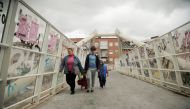 People walk at Puente de Vallecas neighbourhood, amid the outbreak of the coronavirus disease (COVID-20) in Madrid, Spain, September 20, 2020. REUTERS/Javier Barbancho