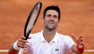 TOPSHOT - Serbia's Novak Djokovic celebrates after victory over Norway's Casper Ruud in their semi final match of the Men's Italian Open at Foro Italico in Rome on September 20, 2020. / AFP / POOL / Clive Brunskill
