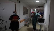 Medical workers, wearing protective face masks, work in the Intensive Care Unit (ICU) where patients suffering from the coronavirus disease (COVID-19) are treated at the Clinique Bouchard-ELSAN private hospital in Marseille, France, September 21, 2020. Pi