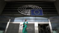 A woman wearing a protective mask leaves the European Parliament headquarters amid the coronavirus disease (COVID-19) outbreak in Brussels, Belgium September 23, 2020. REUTERS/Yves Herman
