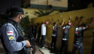 A police officer checks people during an operation against a clandestine party, amid the coronavirus disease (COVID-19) outbreak in Manaus, Brazil, September 25, 2020. Picture taken September 25, 2020. REUTERS/Bruno Kelly