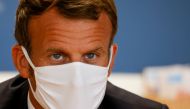 French President Emmanuel Macron, wearing a protective face mask, meets staff and parents during a visit to a center for Maternal and Child Protection (PMI) in Longjumeau, near Paris, France September 23, 2020. Ludovic Marin/Pool via REUTERS