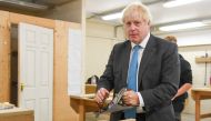 British Prime Minister Boris Johnson tries his hand at woodwork as he visists Exeter College in Exeter, Britain September 29, 2020. Finnbarr Webster/Pool via REUTERS