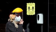 A woman wearing a face mask and a shield walks on the street, amid the spread of the coronavirus disease (COVID-19), in London, Britain, September 29, 2020. REUTERS/Peter Cziborra

