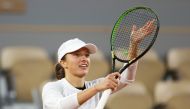 Poland's Iga Swiatek celebrates after winning against Romania's Simona Halep during their women's singles fourth round tennis match on Day 8 of The Roland Garros 2020 French Open tennis tournament in Paris on October 4, 2020. / AFP / Thomas SAMSON