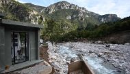 A picture shows sepulchres and a coffin in the partially washed away cemetery of Saint-Dalmas-de-Tende in south-east France, near the Italian border, on October 6, 2020  AFP / Fabien NOVIAL
