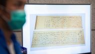 Police show a picture of a calligraphy scroll written by Mao Zedong worth about 300 million USD, that had been recovered but found chopped in half following a robbery that included antique stamps and revolutionary items from mainland China worth an estima