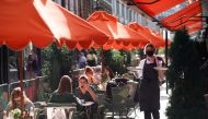 FILE PHOTO: People sit at tables outside restaurants in Soho, amid the coronavirus disease (COVID-19) outbreak, in London, Britain, September 20, 2020. REUTERS/Henry Nicholls/File Photo
