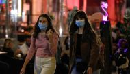 Women wearing protective face masks walk as local authorities in the Italian capital Rome order face coverings to be worn at all times out of doors in an effort to counter rising coronavirus disease (COVID19) infections, in Rome, Italy. October 6, 2020. R