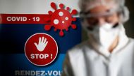 A health worker, wearing a protective suit and a face mask, works at a testing site for the coronavirus disease (COVID-19) in Nantes, France, October 6, 2020. REUTERS/Stephane Mahe
