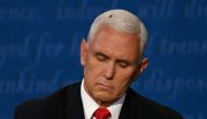  A fly rests on the head of US Vice President Mike Pence as he takes notes during the vice presidential debate against US Democratic vice presidential nominee and Senator from California Kamala Harris in Kingsbury Hall at the University of Utah on October