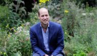 In this file photo taken on July 16, 2020, Britain's Prince William, Duke of Cambridge socially distances as he speaks with service users during a visit to the Garden House of the Light Project in Peterborough. Britain's Prince William on Thursday launche