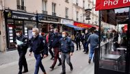 Police officers walk in a street with restaurants in Paris on October 6, 2020, during a patrol to inspect the implementation of new sanitary measures aimed at curbing the spread of the Covid-19 (novel coronavirus) outbreak in the French capital./ AFP / TH