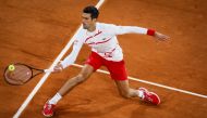 Serbia's Novak Djokovic returns the ball to Spain's Pablo Carreno Busta during their men's singles quarter-final tennis match on Day 11 of The Roland Garros 2020 French Open tennis tournament in Paris on October 7, 2020. / AFP / Thomas SAMSON
