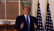(FILES) In this file photo taken on October 05, 2020 US President Donald Trump gives two thumbs up from the Truman Balcony upon his return to the White House from Walter Reed Medical Center, where he underwent treatment for Covid-19, in Washington, DC./ A