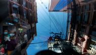 :People wearing protective face masks walk along a street as buildings are reflected on the windshield of a vehicle amid the outbreak of the coronavirus disease (COVID-19), in Kathmandu, Nepal October 8, 2020. REUTERS/Navesh Chitrakar
