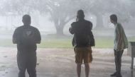 People observe rain and wind as Hurricane Delta makes landfall on October 9, 2020 in Lake Arthur, Louisiana. Go Nakamura/Getty Images/AFP