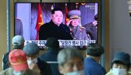 People watch a television news broadcasting a file footage of North Korea's leader Kim Jong Un, at a railway station in Seoul on October 10, 2020. AFP / Jung Yeon-je