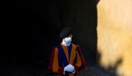 FILE PHOTO: A Swiss guard wearing a protective face mask is seen at the San Damaso courtyard ahead of the weekly general audience at the Vatican, September 16, 2020. REUTERS/Yara Nardi/File Photo