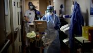 (FILES) In this file photo taken on April 07, 2020 Nurses use medical equipment as they tend to patients infected with COVID-19 at the intensive care unit of the Peupliers private hospital in Paris, on April 7, 2020, on the 22nd day of a strict lockdown i