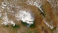 A satellite image shows smoke from a fire around the top of Mount Kilimanjaro, Tanzania October 12, 2020. NASA MODIS Satellite Image/Handout via REUTERS