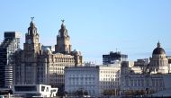 Buildings in Liverpool, including the Liver Building, are pictured across the River Mersey, from Birkenhead, north west England on October 13, 2020.  AFP / Paul ELLIS