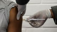 A volunteer receives an injection from a medical worker during the country's first human clinical trial for a potential vaccine against the novel coronavirus, at the Baragwanath hospital in Soweto, South Africa, June 24, 2020. REUTERS/Siphiwe Sibeko/File 