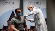 German Health Minister Jens Spahn receives an influenza injection from doctor Harald Bias at Charite hospital, during the spread of the coronavirus disease (COVID-19), in Berlin, Germany, October 14, 2020. REUTERS/Hannibal Hanschke/Pool