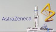 A test tube labeled with the vaccine is seen in front of AstraZeneca logo in this illustration taken, September 9, 2020. REUTERS/Dado Ruvic/File Photo