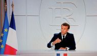 This picture shows a screen displaying French President Emmanuel Macron as he addresses the nation during a televised interview from the Elysee Palace concerning the situation of the novel coronavirus Covid-19 in France, in Paris on October 14, 2020.